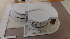 an architectural model of a building on top of a table with several pieces cut out