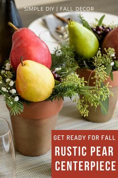 a table topped with vases filled with fruit and greenery