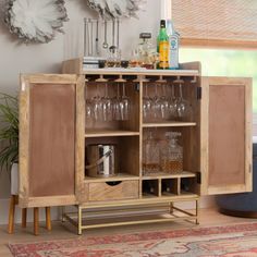 a wooden cabinet with wine glasses on it