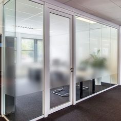 an empty office with glass walls and sliding doors