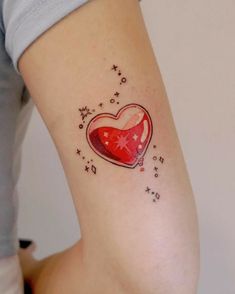 a woman with a heart shaped tattoo on her left arm and the word love is written in small stars