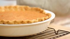 an uncooked pie sitting on top of a cooling rack