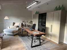 a living room filled with furniture and a wooden table