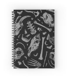 a black and white spiral notebook with skulls, bones, and other things on it