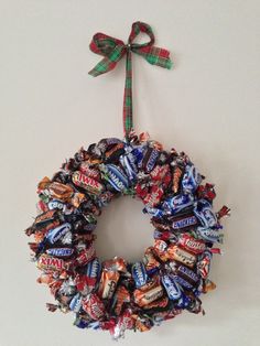 a wreath made out of candy bars hangs on the wall