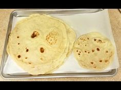 two tortillas sitting on top of a metal pan