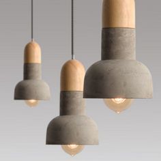 three cement lights hanging from the ceiling with one light turned on and two are turned off