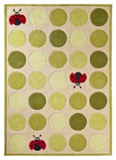 a rug with ladybugs on it in green and beige colors, including dots