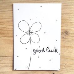 a card with the words good luck written on it and a drawing of a flower