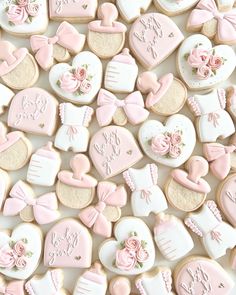 some cookies are decorated with pink and white icing