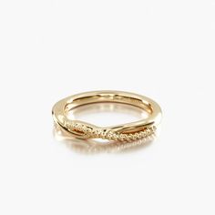 a gold wedding band with diamonds on it