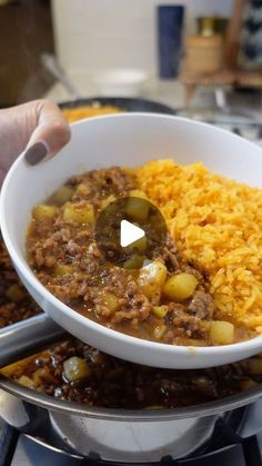 a bowl filled with rice and chili next to other food on top of a stove