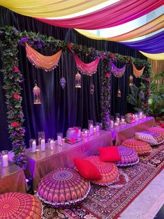 an elaborately decorated banquet table with decorative umbrellas and candles