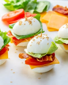 small sandwiches with cheese, lettuce and tomatoes