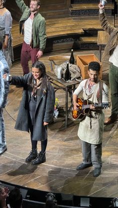 a group of people standing on top of a stage