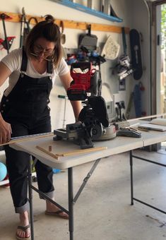 a woman working on a project in a workshop