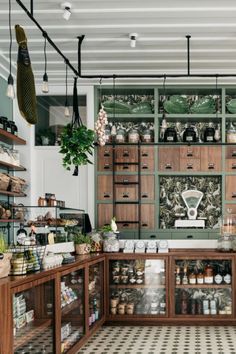 a kitchen with lots of wooden cabinets and shelves filled with spices, condiments and other items