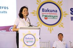 a woman standing at a podium giving a speech