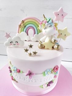 there is a cake with unicorns and stars on it