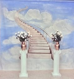 two vases with flowers on them sitting in front of a wall painted with stairs and clouds