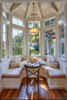 a bay window seat in the corner of a room with wood flooring and white walls