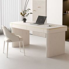 a white desk with a laptop on it