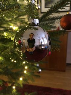 a christmas ornament hanging from the side of a tree