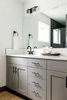 a large bathroom with two sinks and mirrors