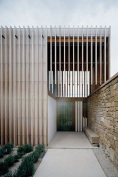 a building with wooden slats on the front and side walls, along with concrete steps leading up to it