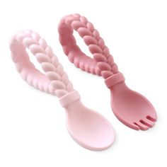 two pink plastic utensils sitting next to each other