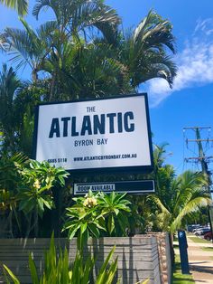 a sign for the atlantic by iron bay in front of palm trees and blue sky