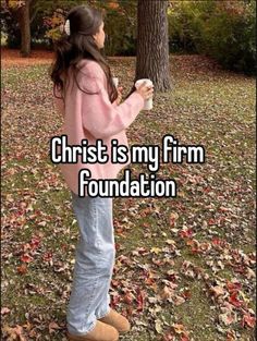 a girl standing in front of a tree with the words christ is my firm foundation