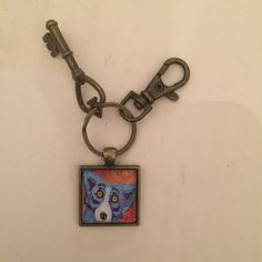 a keychain with a painting of a dog on it