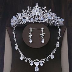 a tiara and earring set on display in a box with the jewelry displayed