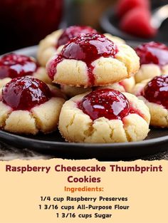 raspberry cheesecake thumbprint cookies on a black plate with text overlay