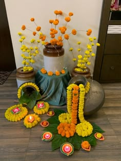 an arrangement of flowers and candles on the floor