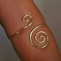 This armlet will be created just for you using thick 12 gauge brass, copper, bronze or German silver. This little lovely is adorned with a small swirl on the top and a larger swirl on the bottom. This armlet will be hand-made to order just for you. Please be sure to select your desired size in available options, or leave the measurement of your arm upon purchase. Place your arm at your side, measure the circumference of your arm where you would like your armband to sit. Thanks for looking! ♥PLEA Upper Arm Jewelry, Armlet Gold, Arm Cuff Jewelry, Upper Arm Bracelet, Gold Arm Cuff, Upper Arm Cuff, Gold Arm Band, Arm Bracelets Upper, Upper Arm Cuffs