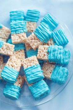 blue and white rice krispy treats on a clear plate