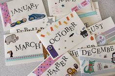 several children's calendars are laid out on the floor with their names and pictures