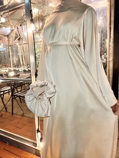 Simple Abaya Maxi Dress. Can be worn with or without belt. Material: Satin White Satin Abaya, Diy Abaya, Beige Abaya, Rich Arab, Cream Satin Dress, Silk Abaya, Hijabi Mode, Beautiful Abayas, Arab Aesthetic