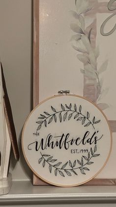 a cross - stitch hoop with the word, whatever else's on it next to a pair of scissors