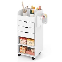 a white cart with drawers and various items on it's sides, including pens, pencils, markers and other office supplies