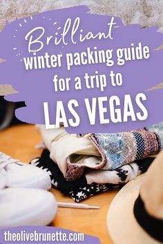 a pile of clothes and hats sitting on top of a wooden floor with the words brilliant winter packing guide for a trip to las vegas