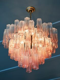 a chandelier made out of glass blocks hanging from the ceiling