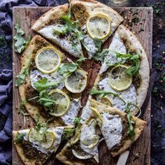 a pizza with lemons and herbs on it