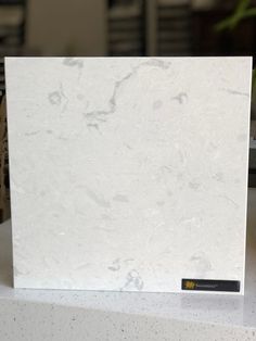 a white marble counter top sitting on top of a table