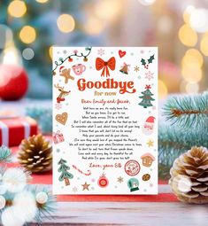 a christmas card with the words goodbye on it next to some pine cones and presents