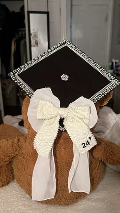 a teddy bear wearing a graduation cap