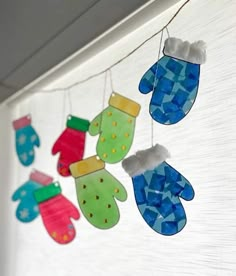 colorful handprinted mittens hanging from a line