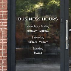 an open door with the words business hours written on it in front of a brick building